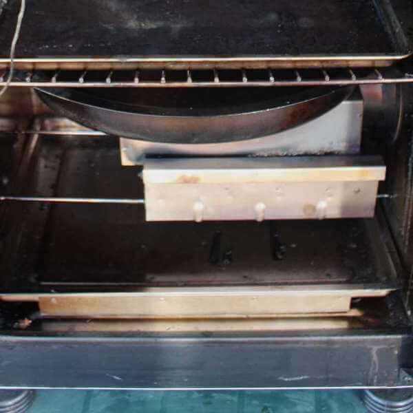 Image Showing Electric Element Box, With Woodchip Smoker Tube and Water Pan Positioned Above